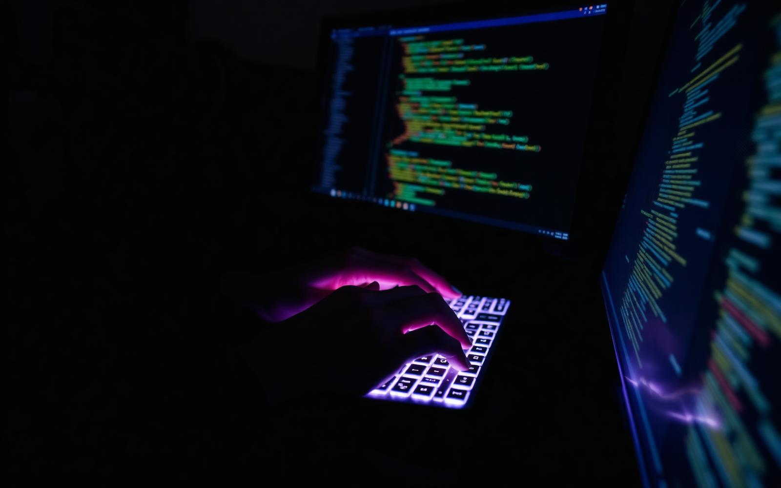 Developer at illuminated workstation